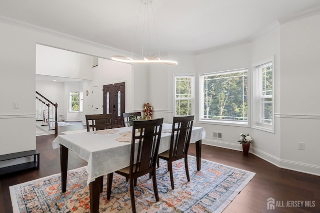 dining space featuring crown molding and dark hardwood / wood-style floors