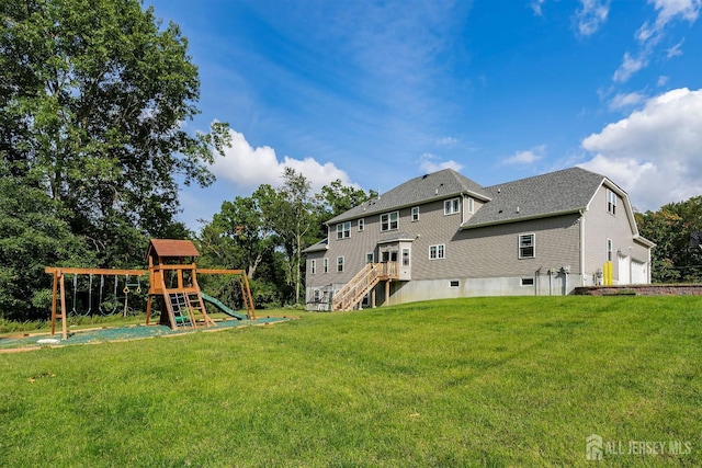 rear view of property featuring a yard and a playground