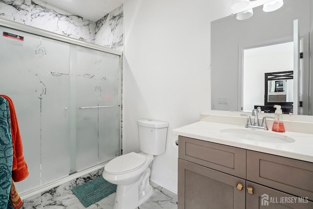 bathroom featuring vanity, toilet, and an enclosed shower