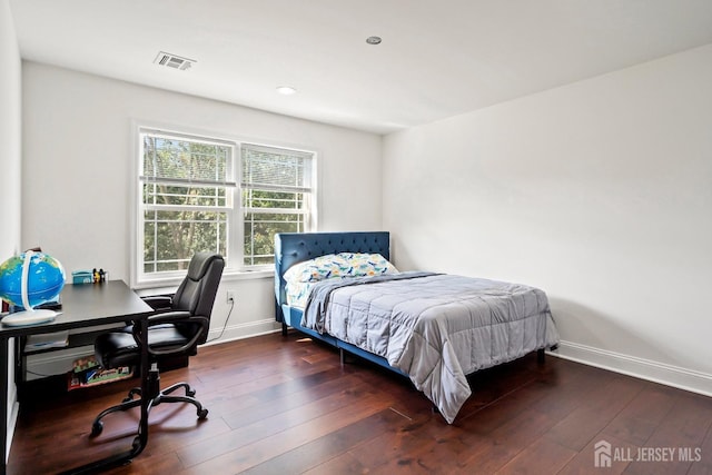 bedroom with dark hardwood / wood-style flooring