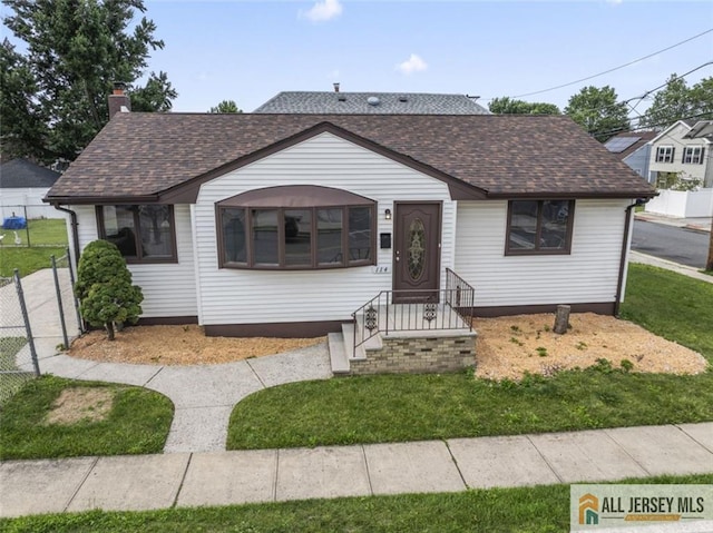 114 Holly St, Port Reading, NJ 07064 - view of front of home with a shingled roof and a chimney