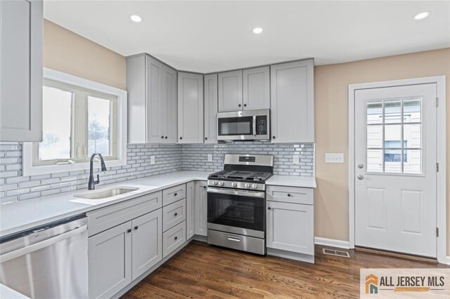 114 Holly St, Port Reading, NJ 07064 - kitchen featuring appliances with stainless steel finishes, gray cabinetry, light countertops, and recessed lighting