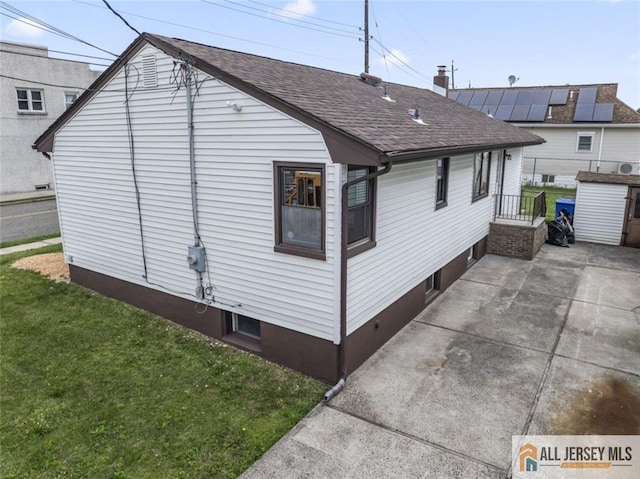 114 Holly St, Port Reading, NJ 07064 - view of property exterior with roof with shingles, a yard, and a patio area