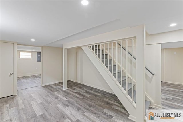 114 Holly St, Port Reading, NJ 07064 - basement featuring stairs, recessed lighting, wood finished floors, and electric panel