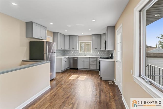 114 Holly St, Port Reading, NJ 07064 - kitchen featuring gray cabinets, stainless steel appliances, dark wood-type flooring, plenty of natural light, and recessed lighting
