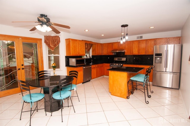 5 Dan Ct, Old Bridge, NJ 08857 - kitchen featuring stainless steel appliances, under cabinet range hood, decorative backsplash, french doors, and a ceiling fan