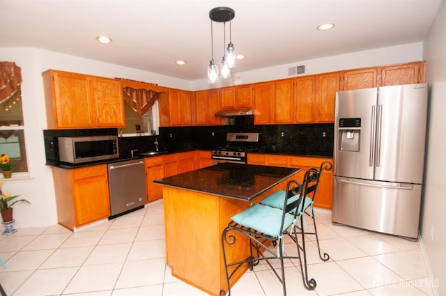 5 Dan Ct, Old Bridge, NJ 08857 - kitchen with stainless steel appliances, tasteful backsplash, under cabinet range hood, decorative light fixtures, and recessed lighting