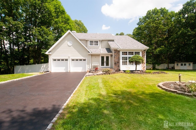 5 Dan Ct, Old Bridge, NJ 08857 - view of front of house with french doors, driveway, an attached garage, stone siding, and roof with shingles