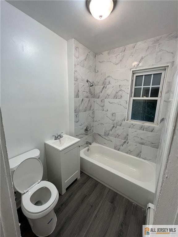 427 John St, Plainfield, NJ 07060 - full bathroom with bathing tub / shower combination, toilet, wood finished floors, and vanity