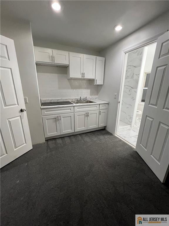 427 John St, Plainfield, NJ 07060 - kitchen with a sink, white cabinetry, black electric cooktop, dark carpet, and recessed lighting