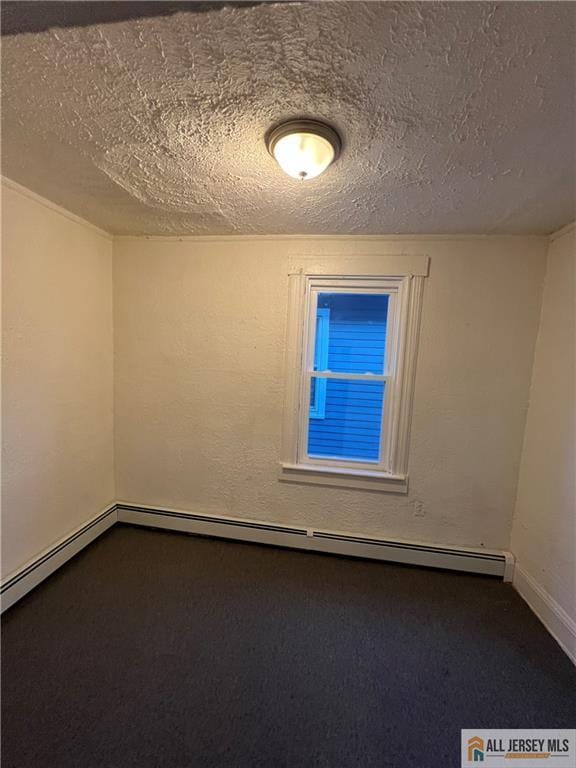 427 John St, Plainfield, NJ 07060 - empty room with a textured ceiling, dark colored carpet, and baseboards