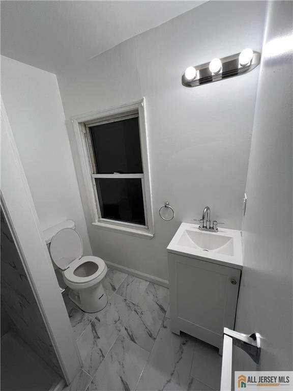 427 John St, Plainfield, NJ 07060 - full bathroom with vanity, toilet, marble look tiles, and a shower stall