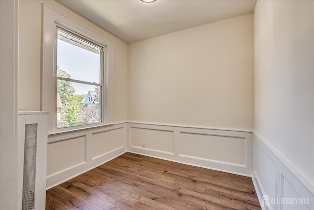 160 Academy St, South Orange Village, NJ 07079 - spare room featuring dark wood-style floors, a wainscoted wall, and a decorative wall