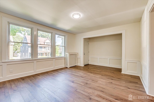 160 Academy St, South Orange Village, NJ 07079 - unfurnished room featuring a decorative wall, plenty of natural light, light wood-style floors, and wainscoting