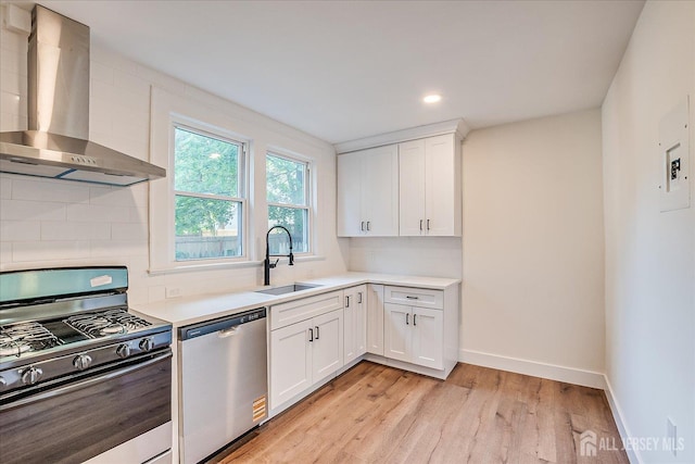 160 Academy St, South Orange Village, NJ 07079 - kitchen with appliances with stainless steel finishes, wall chimney range hood, backsplash, light wood-style floors, and light countertops