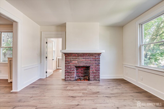 160 Academy St, South Orange Village, NJ 07079 - unfurnished living room with light wood finished floors and a brick fireplace