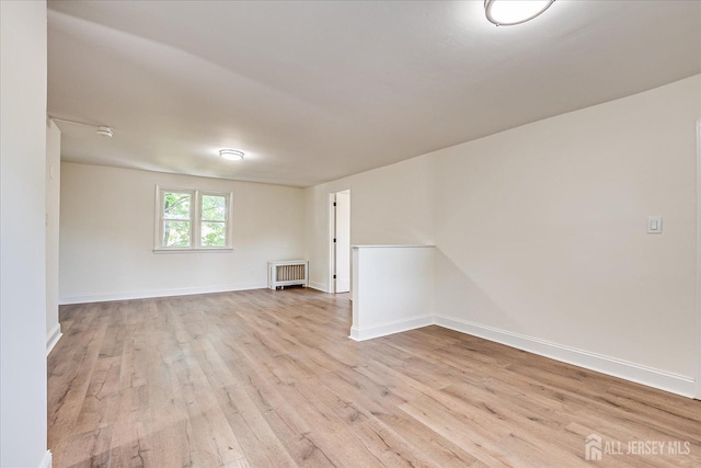 160 Academy St, South Orange Village, NJ 07079 - empty room featuring wood finished floors, radiator heating unit, and a smoke detector