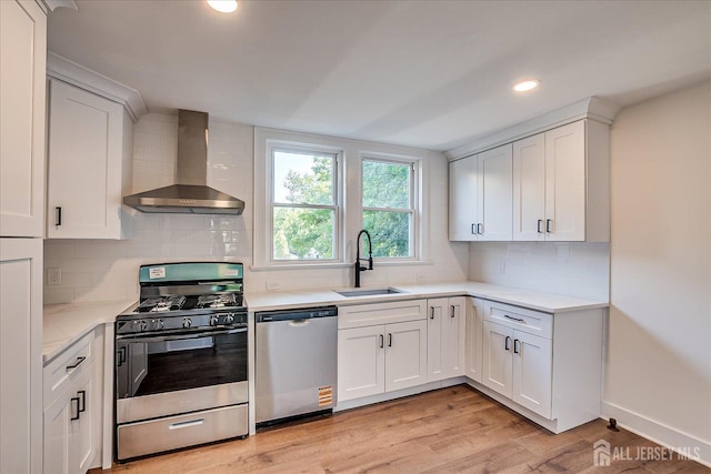 160 Academy St, South Orange Village, NJ 07079 - kitchen with stainless steel appliances, wall chimney range hood, recessed lighting, tasteful backsplash, and white cabinetry