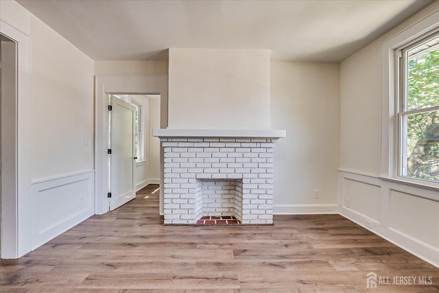 160 Academy St, South Orange Village, NJ 07079 - unfurnished living room with wood finished floors, a fireplace, and a decorative wall