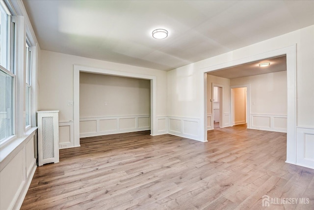 160 Academy St, South Orange Village, NJ 07079 - unfurnished room featuring a decorative wall, healthy amount of natural light, light wood-style floors, and wainscoting