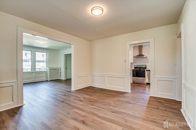 160 Academy St, South Orange Village, NJ 07079 - spare room featuring a decorative wall, wood finished floors, wainscoting, and radiator