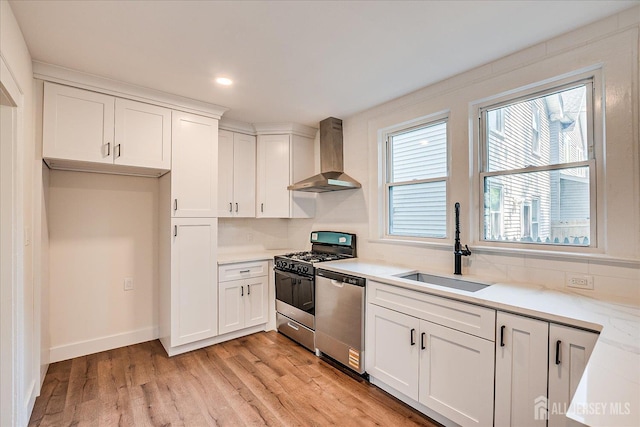 160 Academy St, South Orange Village, NJ 07079 - kitchen with wall chimney exhaust hood, appliances with stainless steel finishes, white cabinetry, light wood-style floors, and recessed lighting
