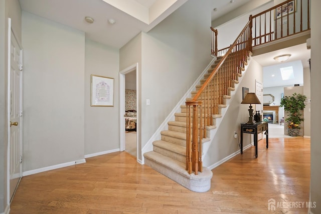 27 Dawson Ln, Monroe, NJ 08831 - foyer featuring stairs, wood finished floors, and a glass covered fireplace
