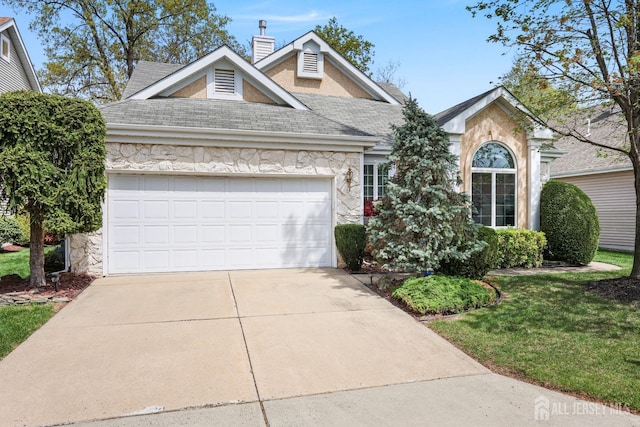 27 Dawson Ln, Monroe, NJ 08831 - traditional-style house featuring stone siding, roof with shingles, driveway, an attached garage, and a chimney
