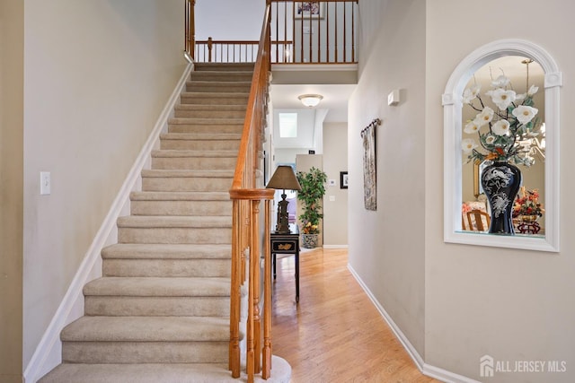 27 Dawson Ln, Monroe, NJ 08831 - staircase with wood finished floors, baseboards, and a high ceiling