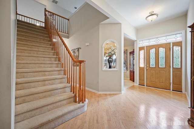 27 Dawson Ln, Monroe, NJ 08831 - entrance foyer featuring baseboards, a towering ceiling, stairway, and light wood-style floors