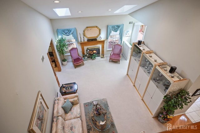 27 Dawson Ln, Monroe, NJ 08831 - carpeted living room featuring a skylight, a glass covered fireplace, and recessed lighting