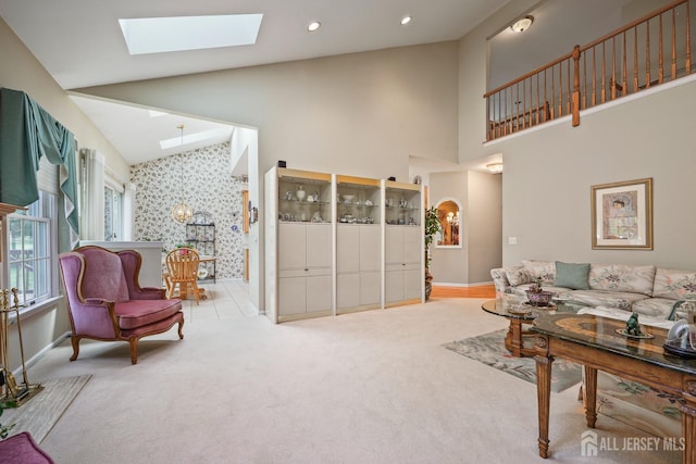 27 Dawson Ln, Monroe, NJ 08831 - living area featuring a skylight, baseboards, high vaulted ceiling, carpet floors, and arched walkways