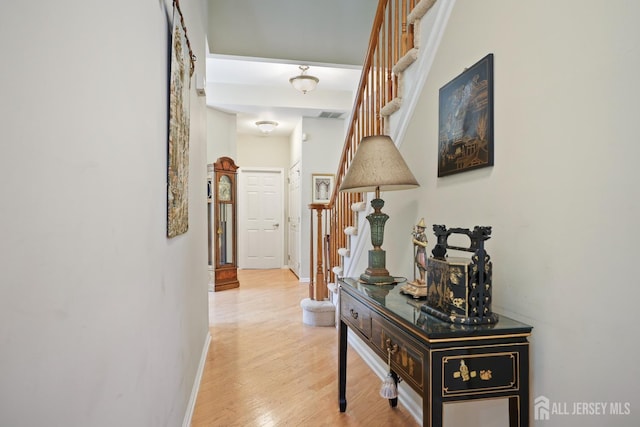 27 Dawson Ln, Monroe, NJ 08831 - hallway featuring stairway, baseboards, and wood finished floors