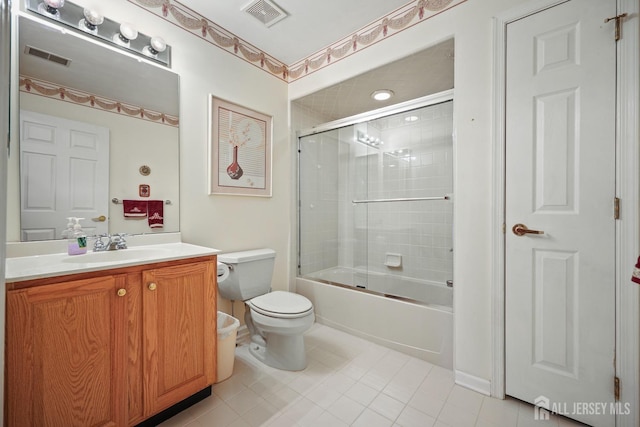 27 Dawson Ln, Monroe, NJ 08831 - bathroom with toilet, vanity, tile patterned flooring, combined bath / shower with glass door, and baseboards