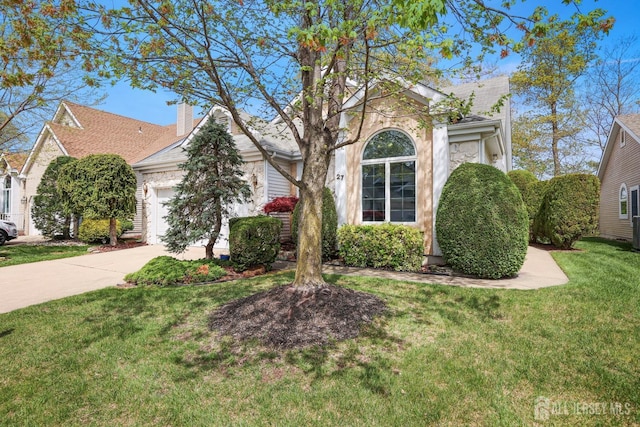 27 Dawson Ln, Monroe, NJ 08831 - view of property hidden behind natural elements featuring an attached garage, concrete driveway, a front yard, and a shingled roof