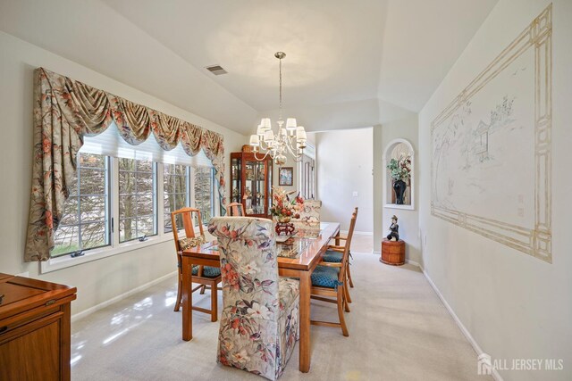 27 Dawson Ln, Monroe, NJ 08831 - dining space featuring a chandelier, light colored carpet, baseboards, and lofted ceiling