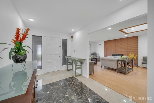 foyer entrance with tile patterned flooring and recessed lighting