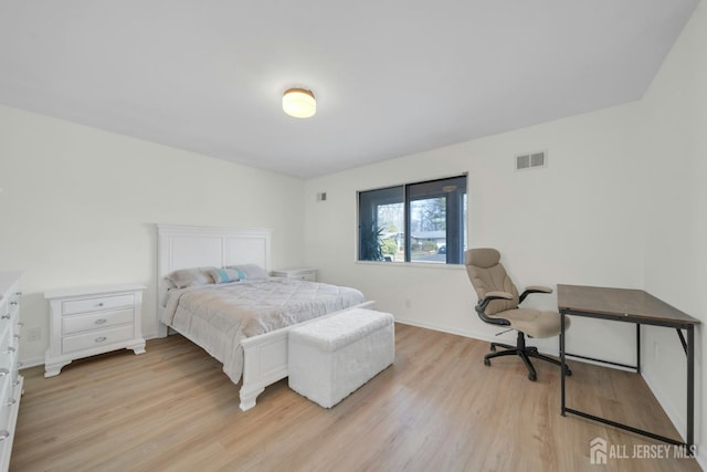 bedroom featuring light wood-style floors, baseboards, and visible vents