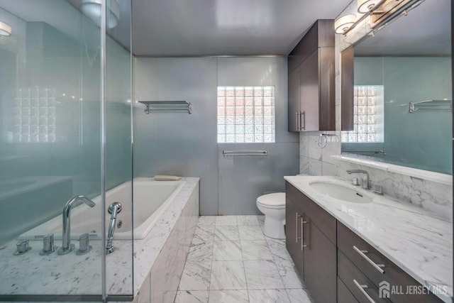 bathroom with a shower with shower door, vanity, toilet, marble finish floor, and a bathtub