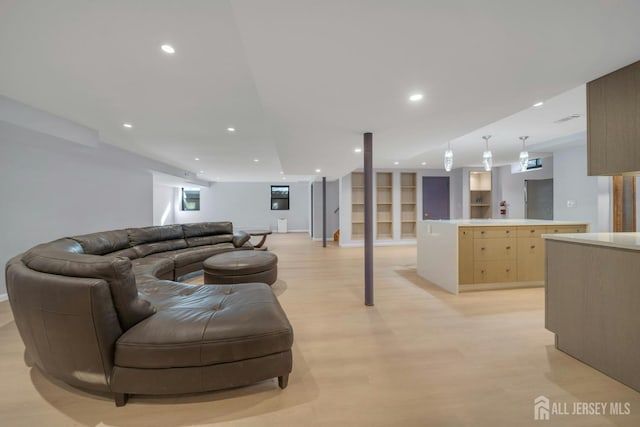 living room with built in features, light wood-type flooring, recessed lighting, and baseboards
