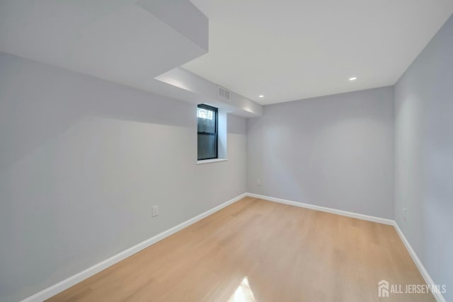 empty room featuring visible vents, baseboards, recessed lighting, and light wood-style floors