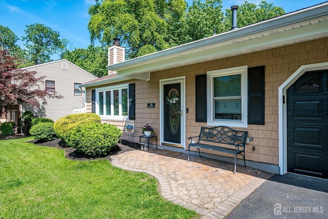 16 Rachele Ct, Old Bridge, NJ 07747 - doorway to property with a chimney, a lawn, covered porch, and a garage