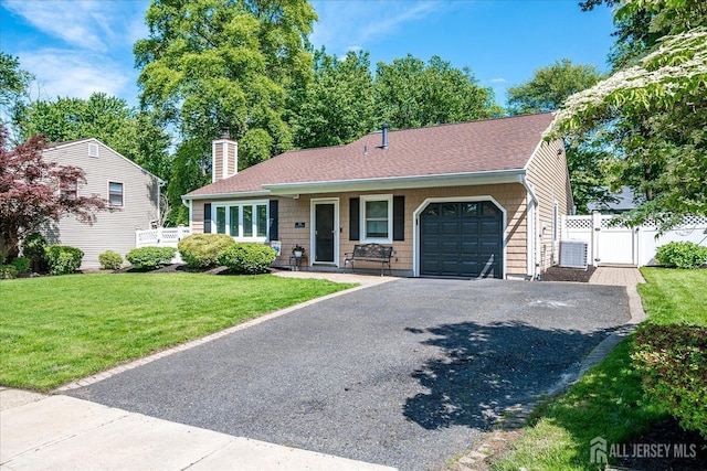 16 Rachele Ct, Old Bridge, NJ 07747 - view of front of home with a garage, driveway, central AC, a chimney, and a gate