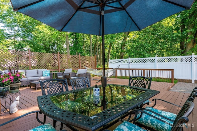16 Rachele Ct, Old Bridge, NJ 07747 - wooden terrace with outdoor dining area, outdoor lounge area, and a fenced backyard