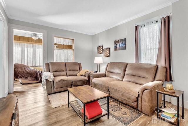 living room with crown molding, wood finished floors, and ceiling fan