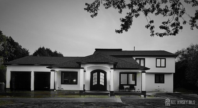 view of front facade with a garage and french doors