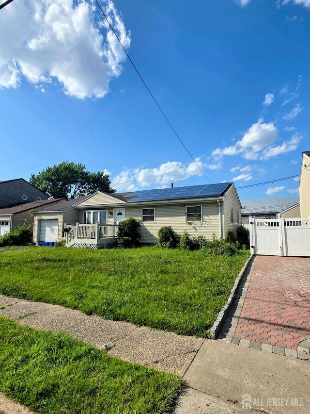 41 Harrison Ave, Carteret, NJ 07008 - ranch-style home featuring a gate, a front yard, and a wooden deck