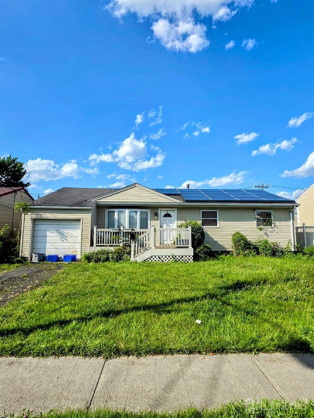 41 Harrison Ave, Carteret, NJ 07008 - ranch-style home with a garage, roof mounted solar panels, dirt driveway, and a front lawn