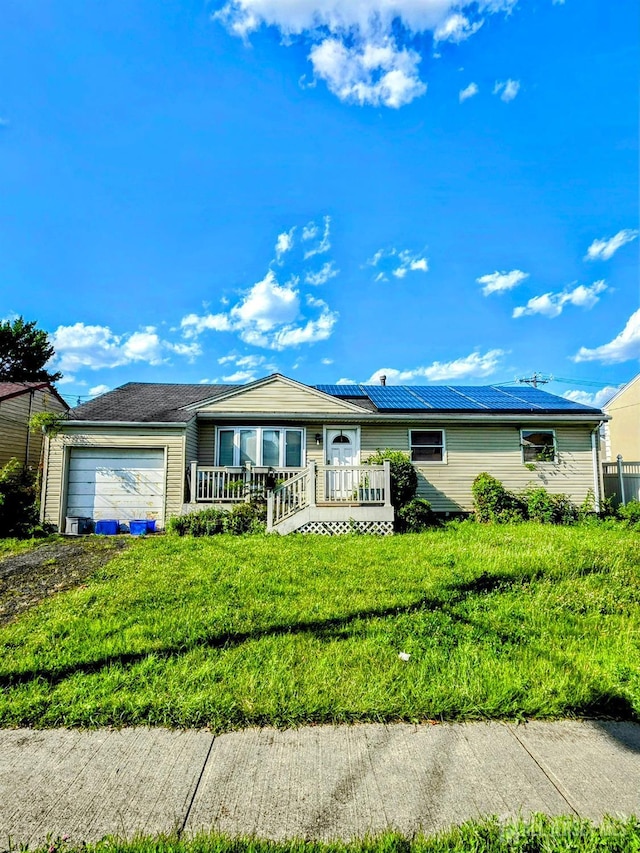 41 Harrison Ave, Carteret, NJ 07008 - single story home with a garage, roof mounted solar panels, and dirt driveway