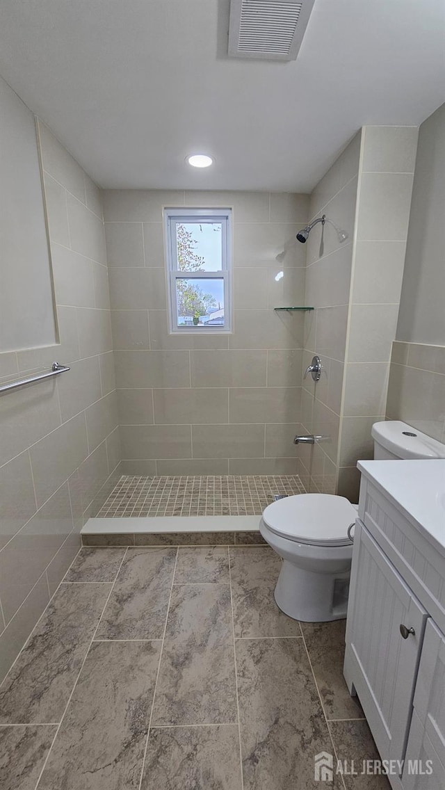 1150 Rahway Ave, Avenel, NJ 07001 - full bath with vanity, toilet, a tile shower, and tile walls